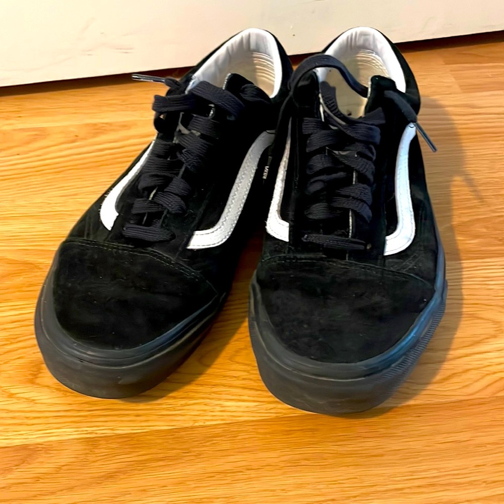 Black and white Vans with black soles